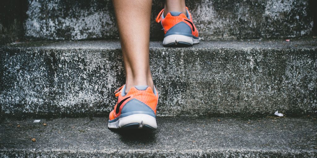 4f4c0c8bthumbnail 4f4c0c8bthumbnail person wearing orange and gray Nike shoes walking on gray concrete stairs Achieving New Year Resolutions with a Healthy and Fit Body 4f4c0c8bthumbnail